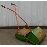 A vintage Qualcast lawn mower with grass box.