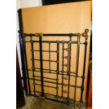 A metal framed double bed with supports with a brass inlay, 143cm wide.