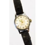 A Timex manual wind shock resistant wristwatch, with Arabic numerals and baton pointers.