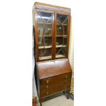 An early 20thC oak bureau bookcase, the upper section with astragal glazed doors revealing