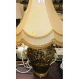 A decorative classical style lamp, with yellow shade.