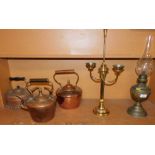 Various copper and brass ware, two branch sconce, oil lamp and three copper kettles. (1 shelf)