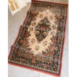 A woollen Belgian rug, geometric floral design predominately in pink, 79cm wide.