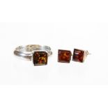 An amber type jewellery set, comprising pair of ear studs and ring on plain shank, marked 925,