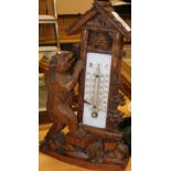 A very early 20thC Black Forest bear thermometer, the arched case aside a standing bear with flowers
