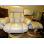 A cream leather swivel chair, 88cm wide and footstool.