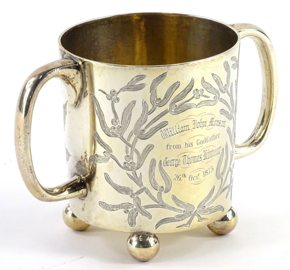 A Victorian silver two handled christening mug, engraved with a bird, seated on a branch of holly,
