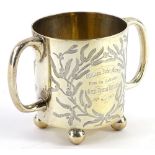 A Victorian silver two handled christening mug, engraved with a bird, seated on a branch of holly,