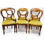 A set of six Victorian mahogany and walnut balloon back dining chairs, each with a padded back and