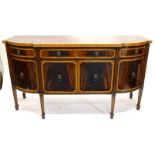 A late 19thC mahogany and boxwood strung sideboard, the top with a serpentine front above a frieze