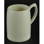 A Keith Murray Wedgwood cream glazed mug, printed marks to underside, 12cm high.