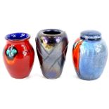 Three Poole pottery vases, to include black lustre glaze example and a ginger jar, each in
