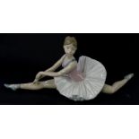 A Nao porcelain model of a seated ballet dancer, 38cm wide.