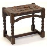 A small oak stool, the rectangular top with a rectangular woven top, on turned supports, with H