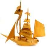 A carved Eastern teak model of a two masted sailing boat, with sliding cover, 65cm high.