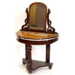 A Victorian mahogany Dutchess type dressing table, the rectangular mirrored plate, on pierced carved