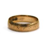 A 9ct gold wedding band, with rubbed etched design, ring size J, 2g all in.