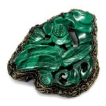 A malachite brooch, of carved design with filigree design bordering, and single row back, marked