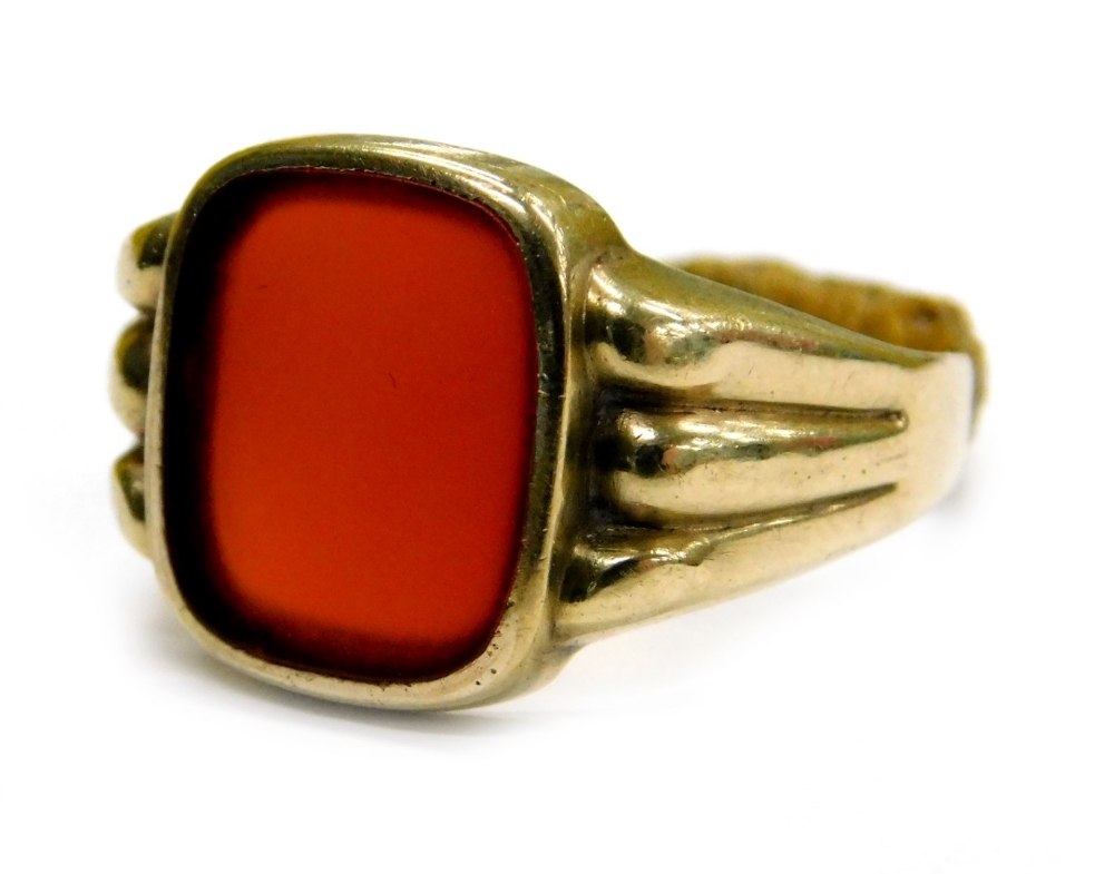 A gent's signet ring, set with rectangular cut red/orange agate, in rub over setting, with a three