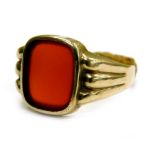 A gent's signet ring, set with rectangular cut red/orange agate, in rub over setting, with a three