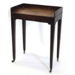 A George III mahogany small side table, with a galleried top on square tapering legs, with brass