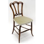 A Victorian walnut nursing chair, with a fan shaped back, padded seat, on turned tapering legs.