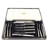 A set of six silver handled dessert knives and forks, each with stainless blade stamped John