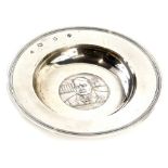 A commemorative silver Armada dish, cast centrally with a medallion of Winston Churchill, dated 1874