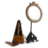 A late Victorian ebonised spelter and brass shaving stand, with circular inlaid wooden mirror,