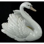 A Lladro porcelain model of a swan, numbered to underside 5231, 20cm wide.