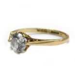 A 9ct gold solitaire ring, set with imitation diamond stone, in eight claw setting, with V splayed