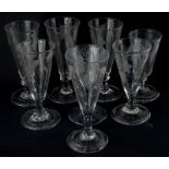 A collection of late 18th/early 19thC ale flutes, each engraved with wheat etc., three with a fold