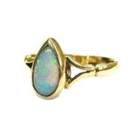 A 9ct gold opal set dress ring, with tear drop shaped opal stone, in rub over setting, on V