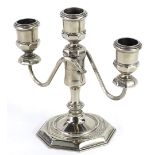 A silver plated three branch candelabra in mid 18thC style, on a domed octagonal base, 17cm wide.