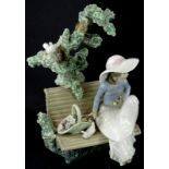 A Lladro porcelain model of a lady, seated on a bench beside doves etc., 23cm high.