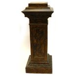 A late 19thC pedestal, painted to simulate walnut, with a stepped top, a leaf carved frieze and
