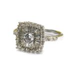 An 18ct white gold and diamond dress ring, with central round brilliant cut diamond in four