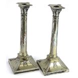 A pair of late 19thC silver plated neo classical candlesticks, each decorated with swags, patera,