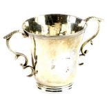 A continental silver coloured metal two handled cup, of tapering form with a moulded rim and