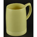 A Keith Murray Wedgwood yellow glazed mug, printed marks to underside, 12cm high.