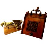 A late Victorian coal scuttle, the lid carved with flowers and leaves and a brass ornament