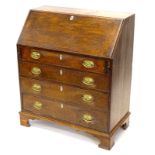 A George III oak and mahogany cross banded bureau, the fall enclosing a fitted interior above four