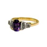 An 18ct gold and platinum amethyst and diamond dress ring, set with oval cut amethyst stone in