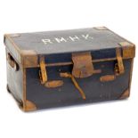 A canvas and brown leather trunk, the lid bearing the initials R.M.H.K. Provenance: The Estate of