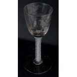 An 18thC wine glass, the tapering bowl engraved with wheat, birds, etc., on an opaque twist stem