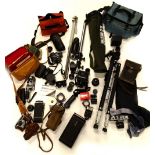 A quantity of camera equipment, to include a Praktica MTL3, various lens, small cameras, tripods,