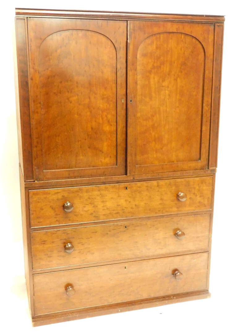 A Victorian plum pudding mahogany clothes press, the top with a moulded cornice above two arched