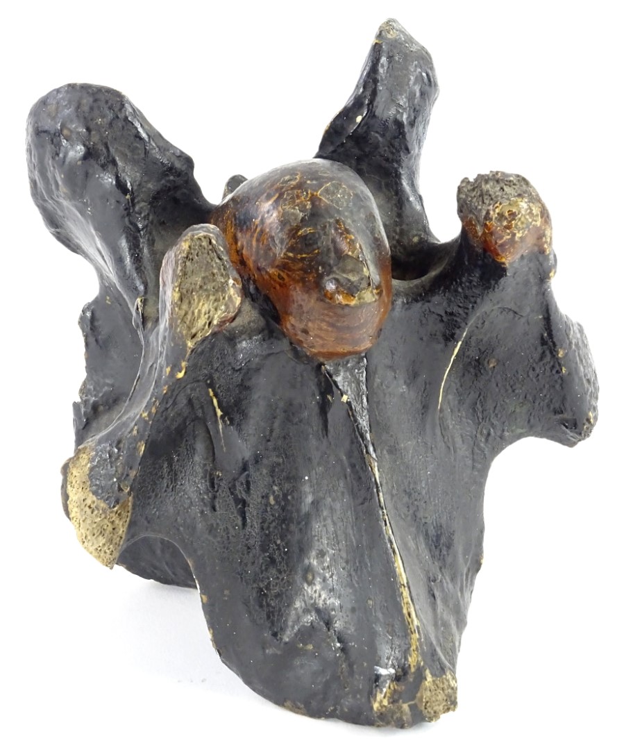 An unusual 19thC carved horse's vertebrae, decorated in the form of John Wesley, 14cm high.