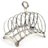 A George IV silver six division toast rack, with reeded and scroll cast handle, concave base and