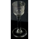 An 18thC wine glass, with wheel cut engraving of flowers and leaves, plain tapering stem and fold